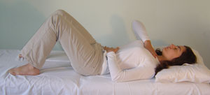 a person lying in bed practicing slimming qigong